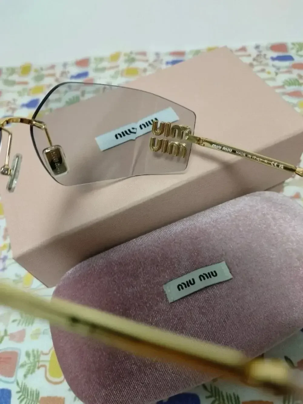 Miu Miu Rimless Grey Sunglasses with Oversized Gold Logo